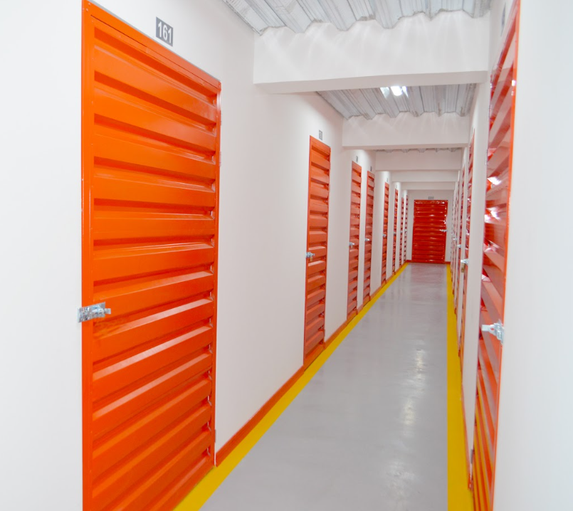 Pasillo de minibodegas con puertas naranjas